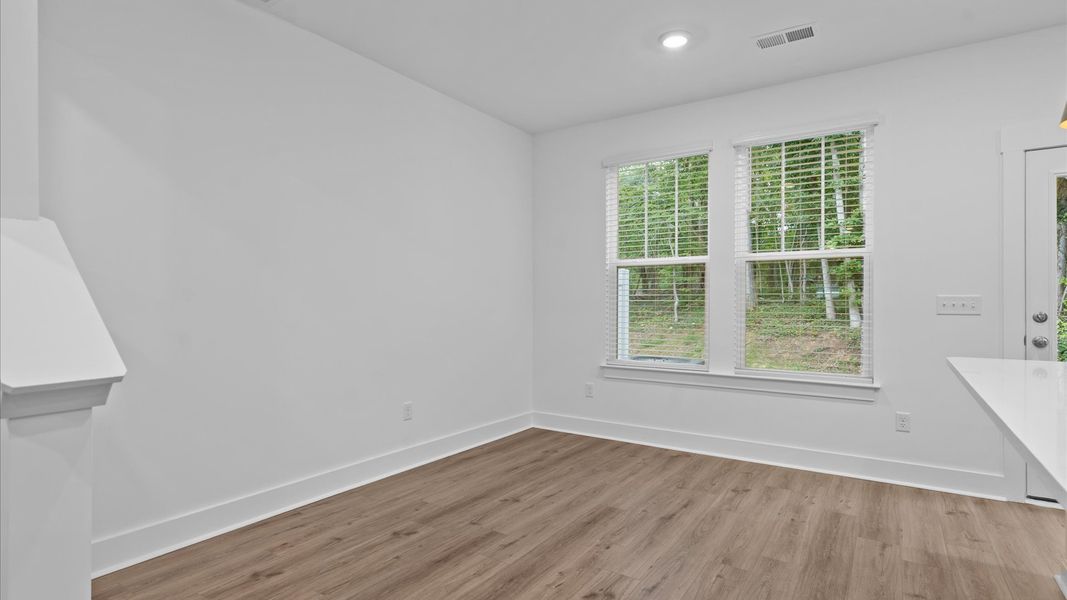 Elegant breakfast area with hardwood flooring and open-concept flow in this first-class DRB Homes design Elegant breakfast area with hardwood flooring and open-concept flow in this first-class DRB Homes design