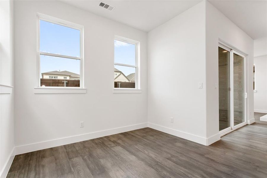 Empty room featuring dark hardwood / wood-style floors