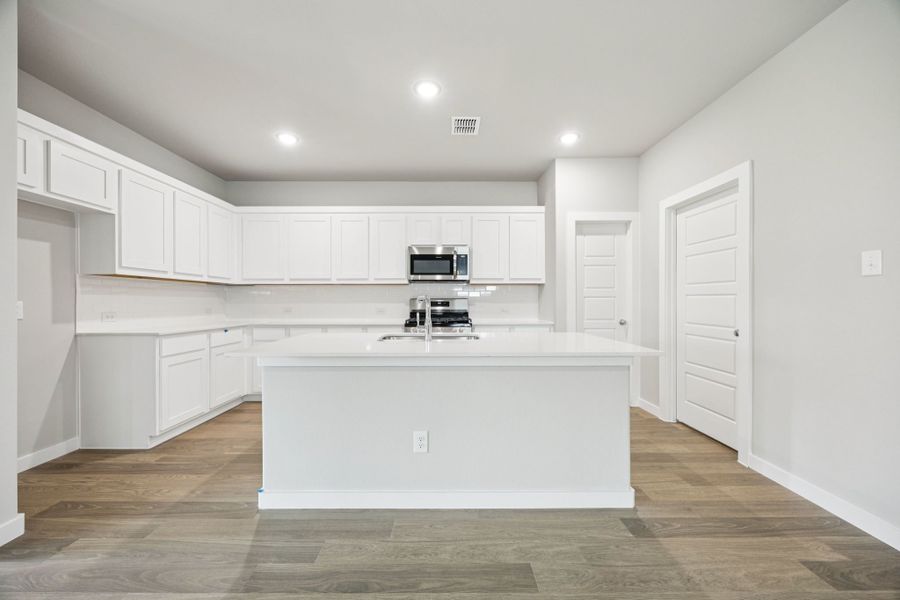 Kitchen in the Hayden home plan by Trophy Signature Homes – REPRESENTATIVE PHOTO