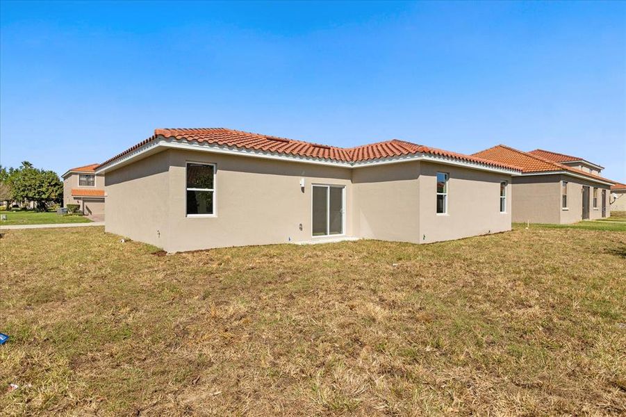 Front exterior of a new home in , Kissimmee, FL, highlighting curb appeal (Image 13).