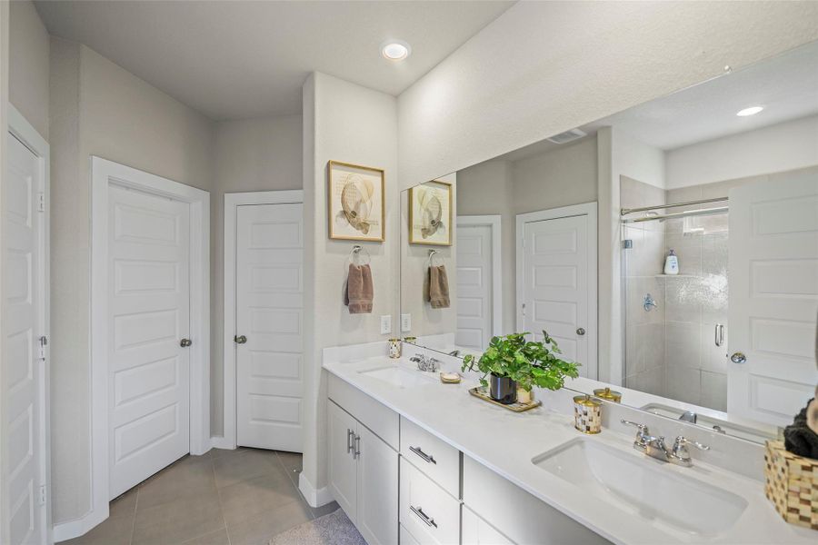 Elegant bathroom featuring a spacious dual-sink vanity and modern fixtures, with ample storage.