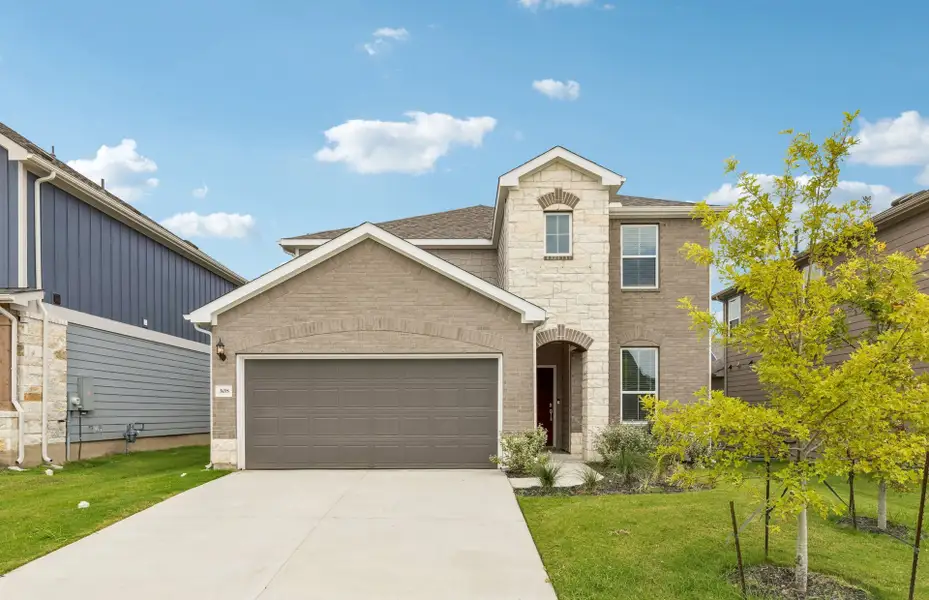 Front exterior of a new home in Patterson Ranch, Georgetown, TX, highlighting curb appeal (Image 2). Front exterior of a new home in Patterson Ranch, Georgetown, TX, highlighting curb appeal (Image 2).