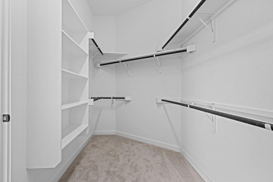 Walk-in closet in Primary Bedroom Walk-in closet in Primary Bedroom