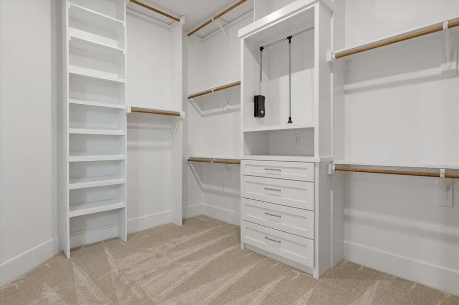 Walk in closet with light carpet