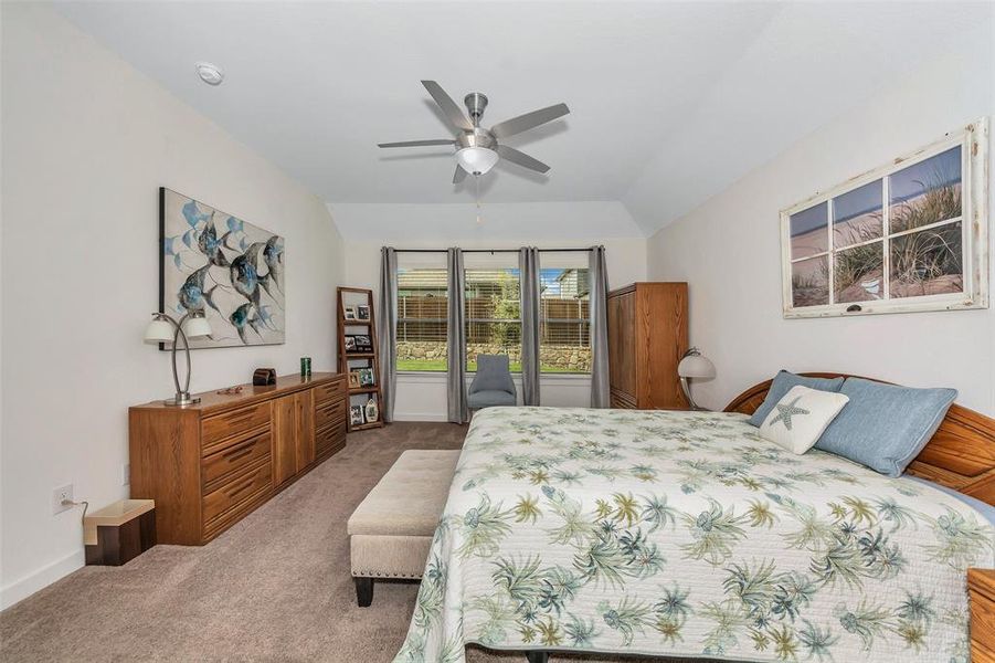 Carpeted bedroom with ceiling fan