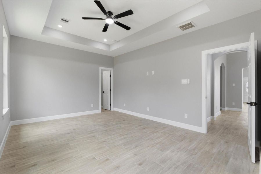 Light-filled primary retreat with a soft neutral palette and expansive windows. Meticulously detailed with clean lines and premium finishes - and TWO walk in closets!