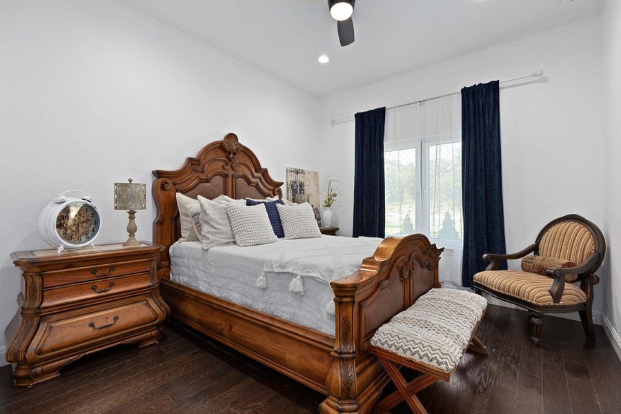 Bedroom featuring dark wood-style floors, a ceiling fan, and recessed lighting Bedroom featuring dark wood-style floors, a ceiling fan, and recessed lighting