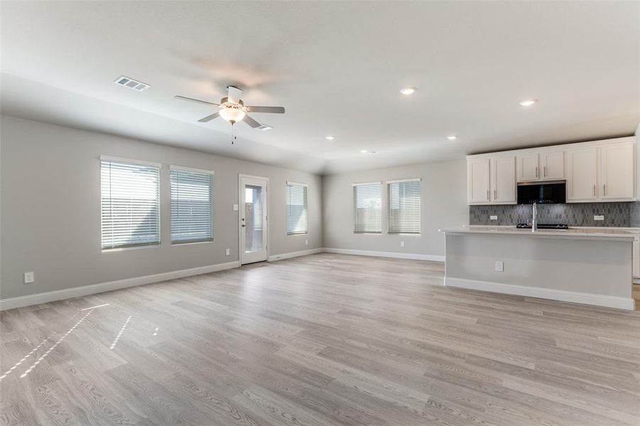 Unfurnished living room featuring light wood-style floors, recessed lighting, and a ceiling fan