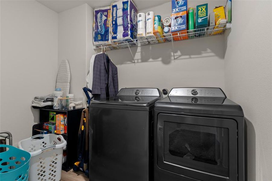 Washroom with washing machine and clothes dryer