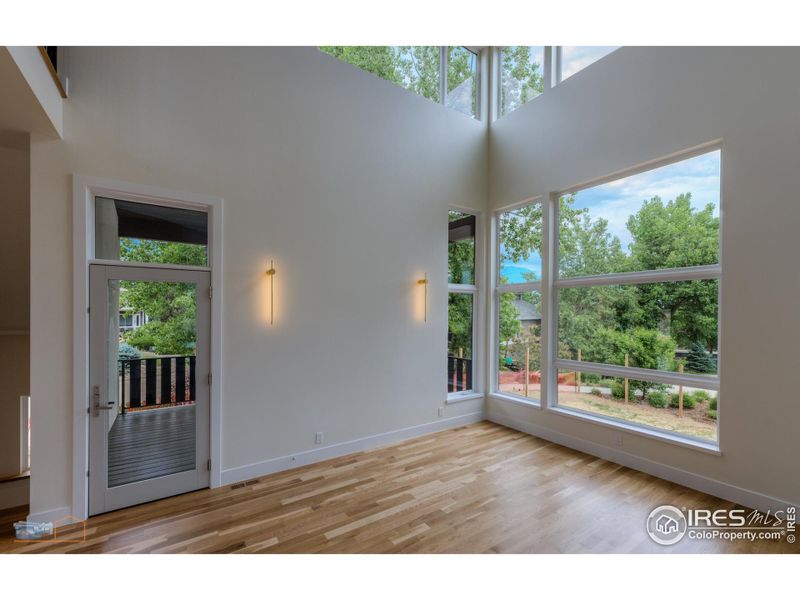 Dining Room With 2 Story Ceiling And Walls Of Glass. Access To The Main Floor Covered Deck.