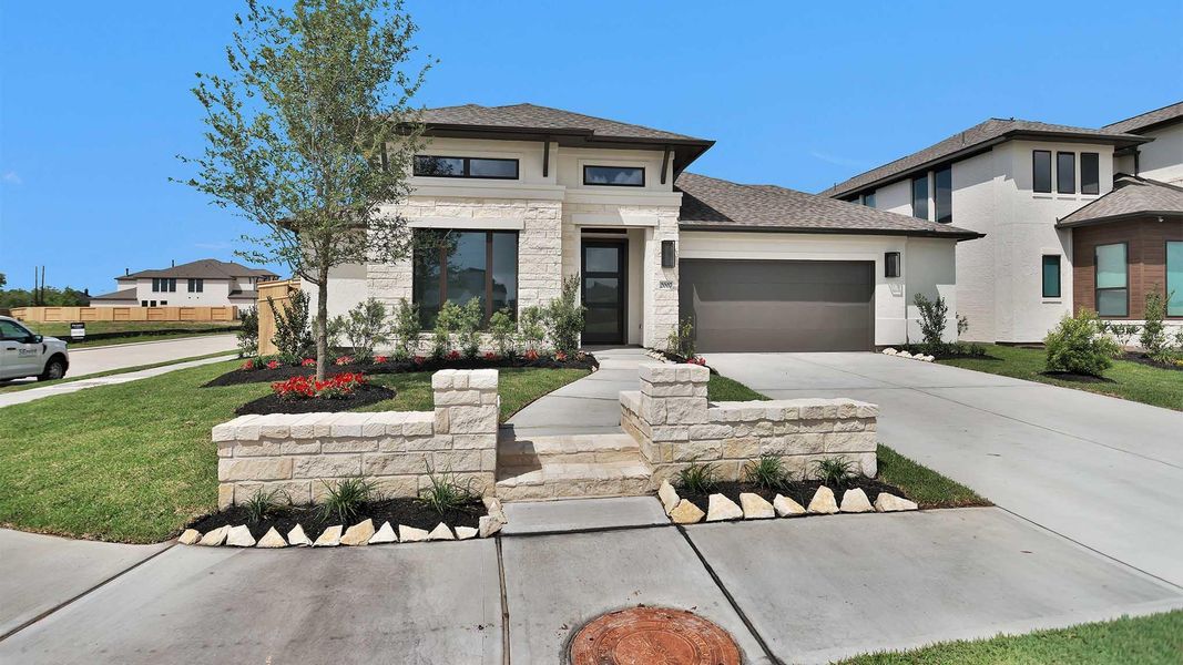 Front exterior of a new home in Sienna, Missouri City, TX, highlighting curb appeal (Image 2). Front exterior of a new home in Sienna, Missouri City, TX, highlighting curb appeal (Image 2).