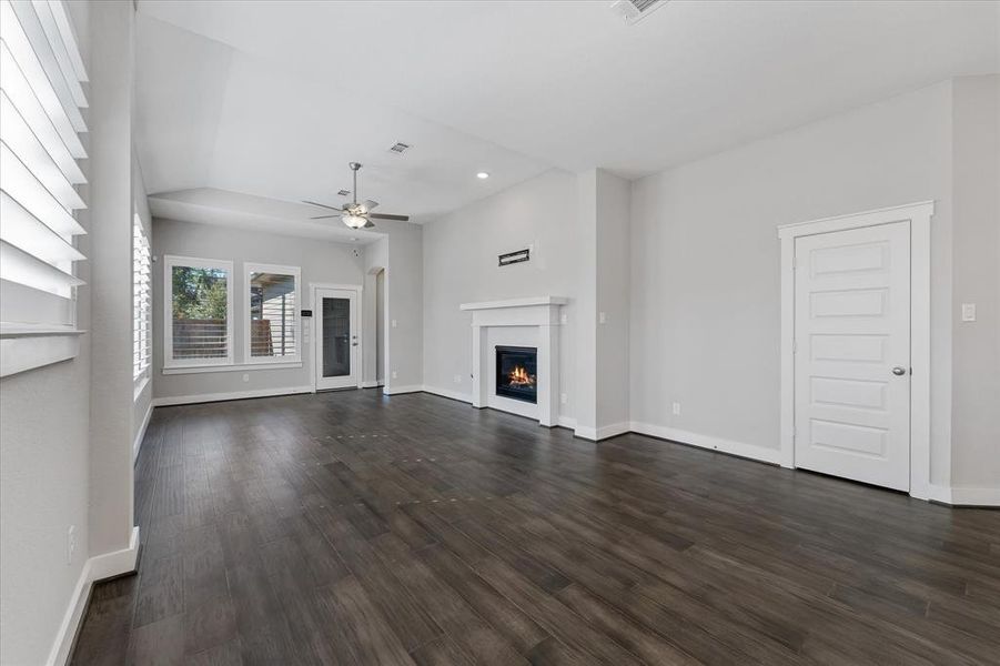 Laminate wood flooring in this cozy living area with a fireplace.