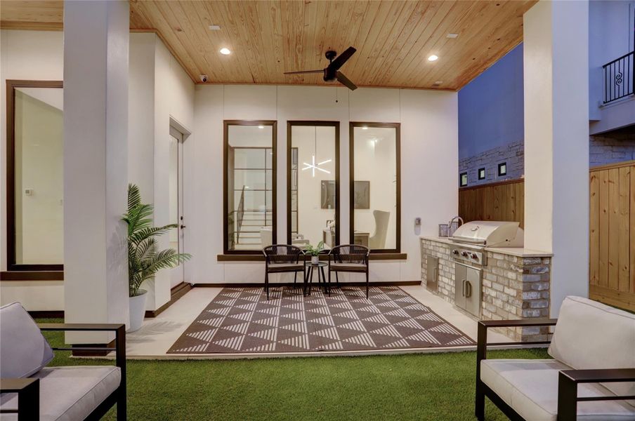 Situated off the living room, primary suite, and study is the outdoor kitchen lanai and artificial turf courtyard space.