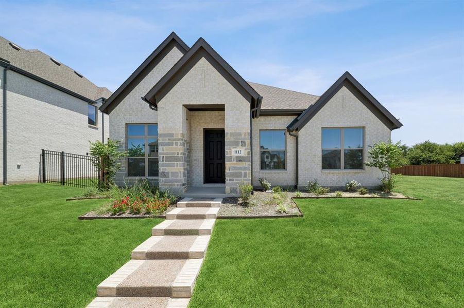 Front exterior of a new home in Karis - Village Series, Crowley, TX, highlighting curb appeal (Image 1). Front exterior of a new home in Karis - Village Series, Crowley, TX, highlighting curb appeal (Image 1).