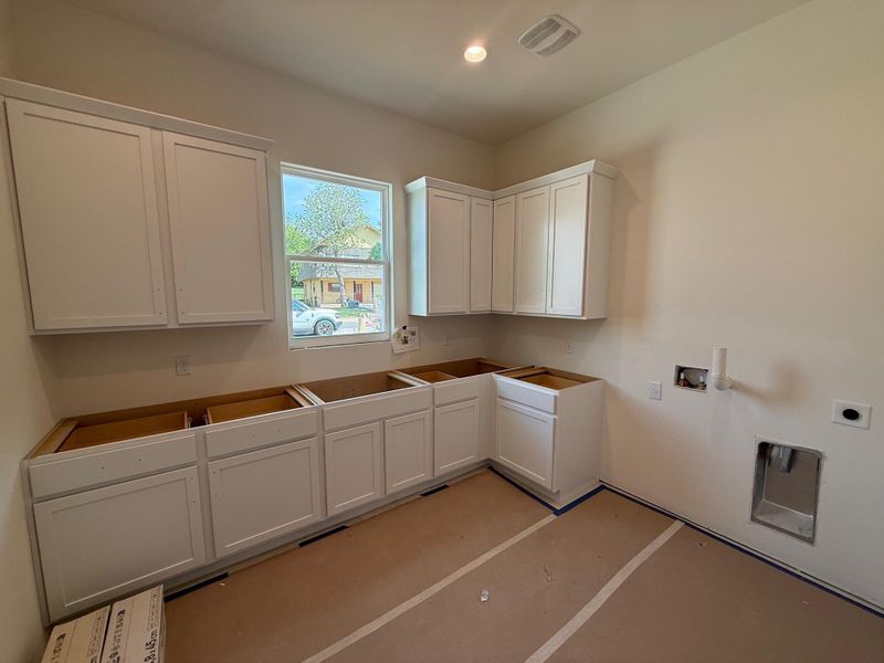 Laundry area with washer hookup, cabinet space, and electric dryer hookup