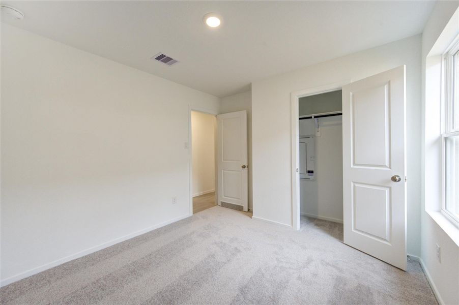 Primary bedroom with comfortable space and natural light