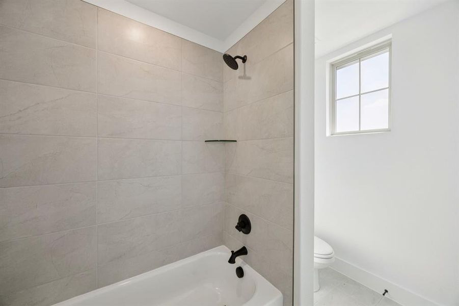 Full bathroom with shower / washtub combination and tile patterned flooring Full bathroom with shower / washtub combination and tile patterned flooring