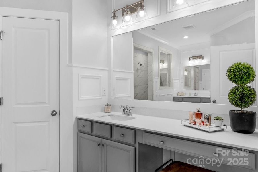 Primary en suite bathroom with dual vanities