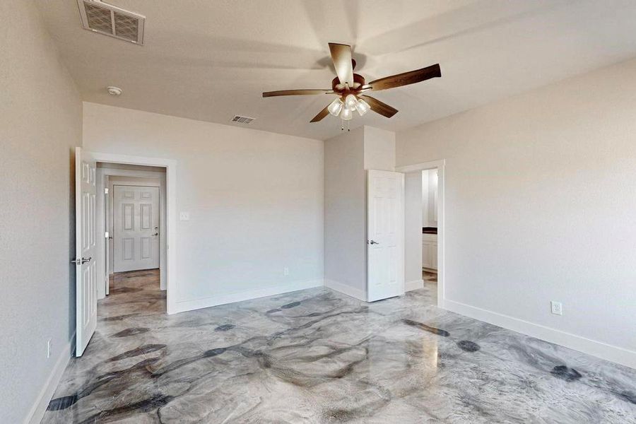 Unfurnished room with concrete floors, visible vents, and baseboards