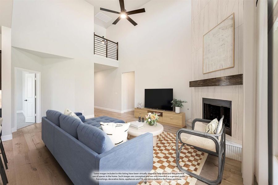 Living room with two-story ceiling, shiplap fireplace, ceiling fan, and hardwood floors Living room with two-story ceiling, shiplap fireplace, ceiling fan, and hardwood floors