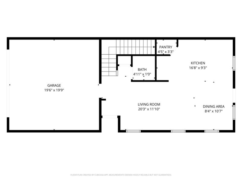 This floor plan features a spacious garage, a large living room, and an open kitchen with an adjoining dining area. There's also a bathroom and a pantry near the kitchen, offering convenient storage.
