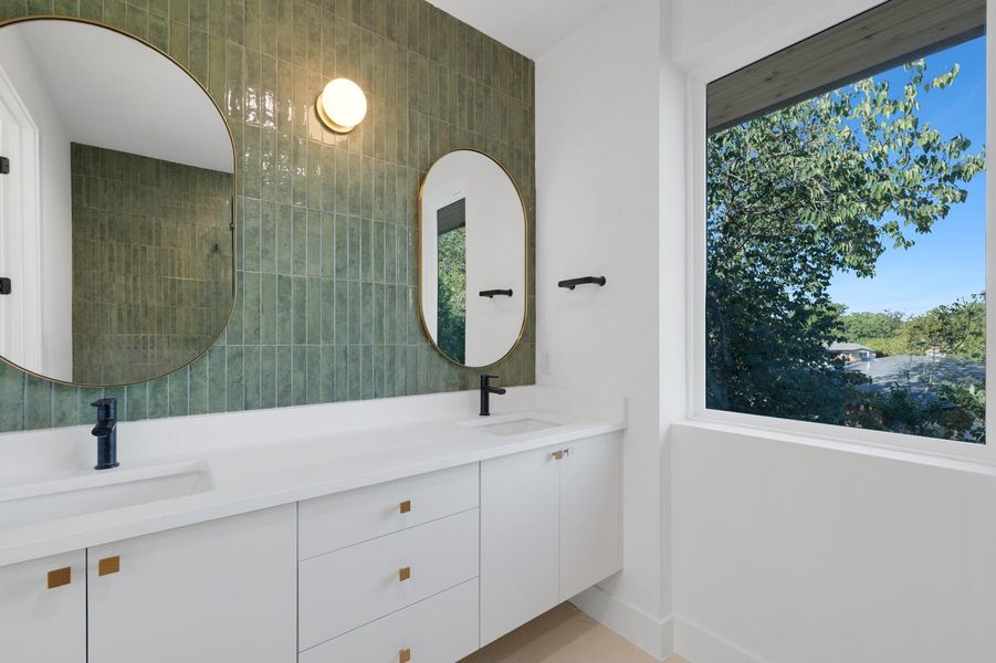 Bathroom featuring double vanity and tile walls