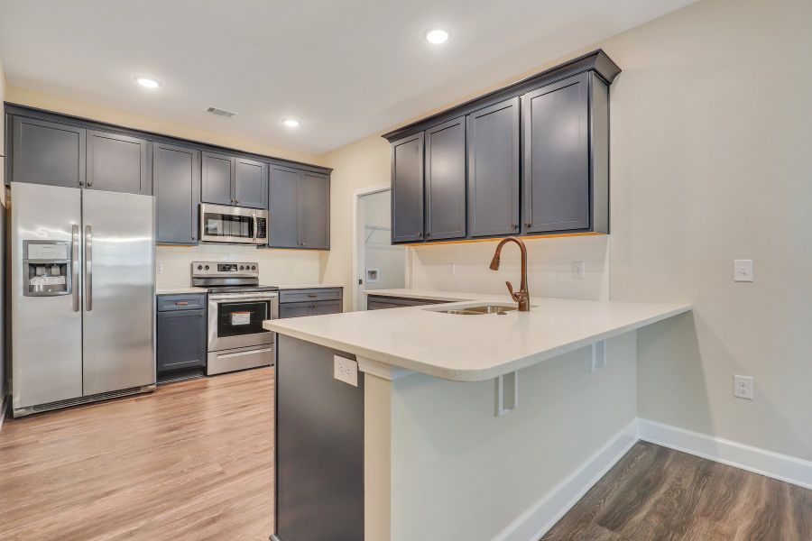 Hatteras – Kitchen with Blue Cabinets and Breakfast Bar