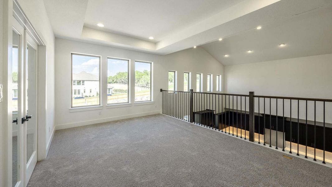 Spare room with carpet floors, recessed lighting, a tray ceiling, and lofted ceiling