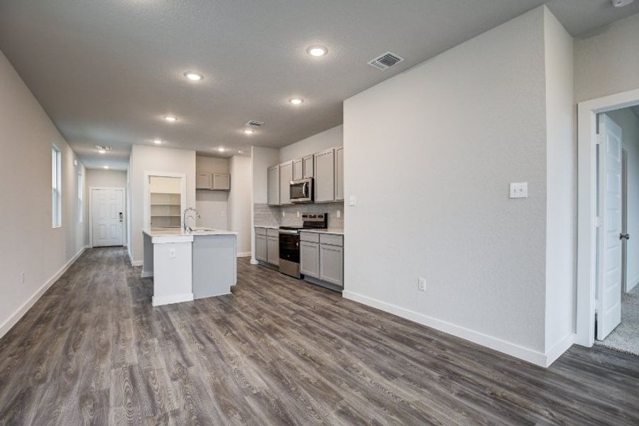 A kitchen with white cabinets.