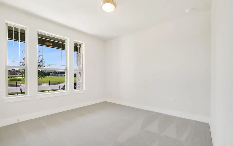 Spare room featuring baseboards and light colored carpet