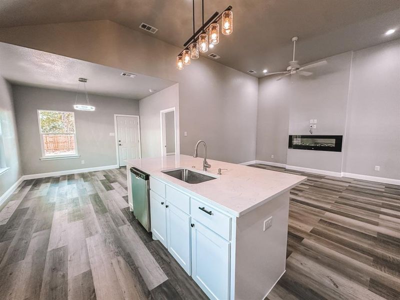 open kitchen with island and quartz countertops