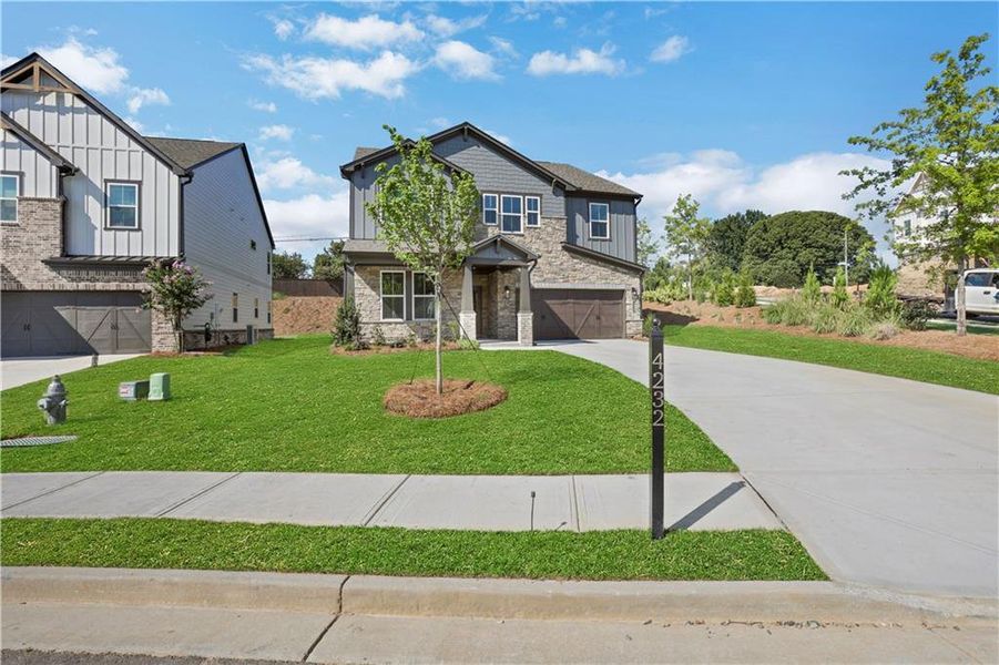 Front exterior of a new home in The Paddocks at Doc Hughes, Buford, GA, highlighting curb appeal (Image 26).