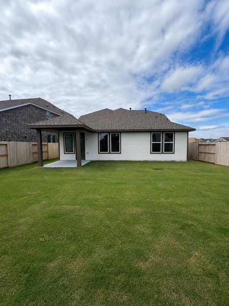 Spacious backyard with covered patio