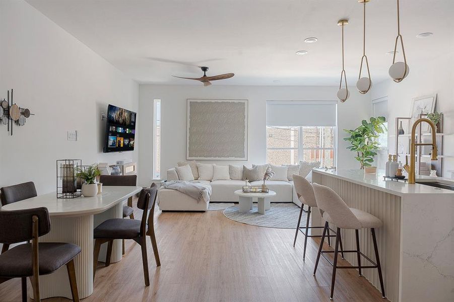 Open-concept living space featuring wood-finish flooring, recessed lighting, and a modern ceiling fan
