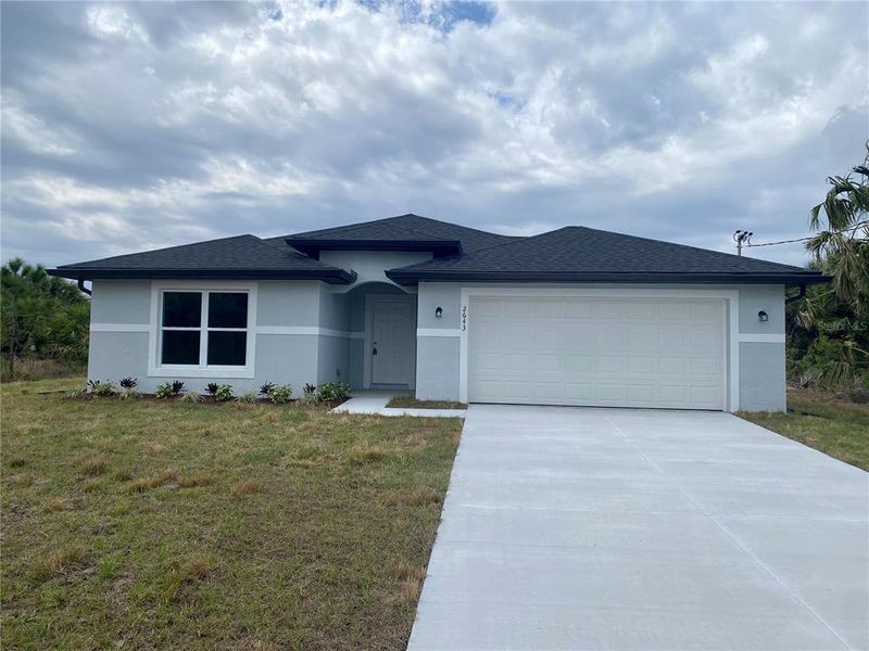 Front exterior of a new home in , North Port, FL, highlighting curb appeal (Image 2). Front exterior of a new home in , North Port, FL, highlighting curb appeal (Image 2).