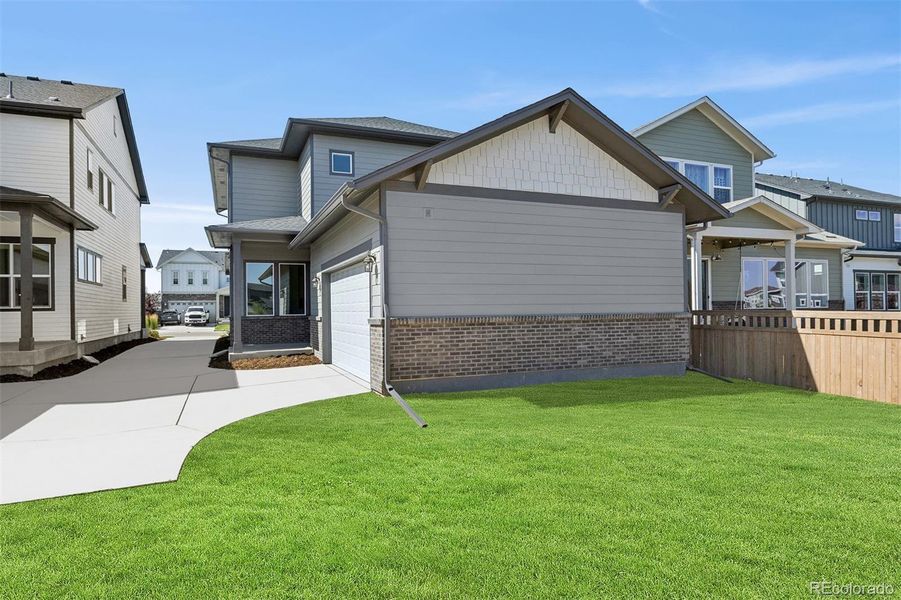 Front exterior of a new home in Painted Prairie Cottage, Aurora, CO, highlighting curb appeal (Image 22).