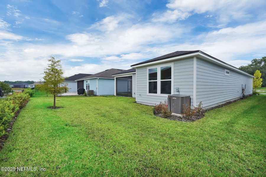Front exterior of a new home in Summer Bay at Grand Oaks, St. Augustine, FL, highlighting curb appeal (Image 21).