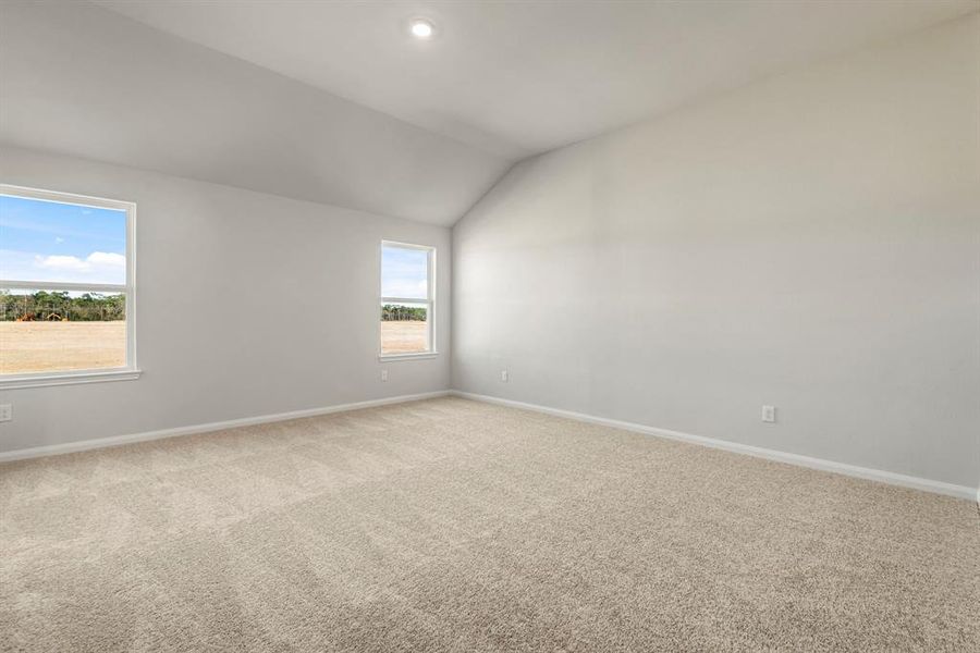 The master bedroom is filled with natural light and space for a reading nook or cozy seating area.