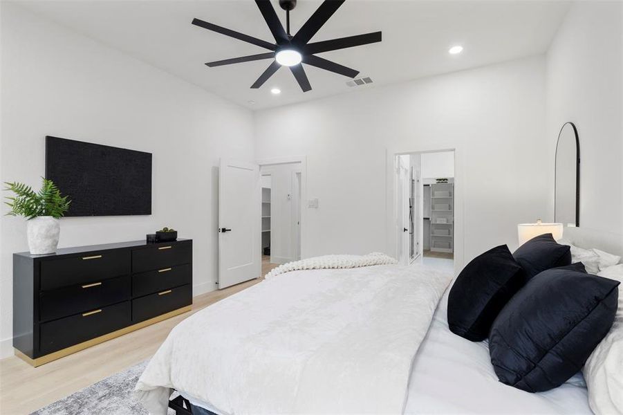 Bedroom featuring light wood-style flooring, recessed lighting, a spacious closet, and ceiling fan
