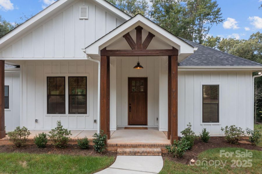 Close-up view of the front exterior highlights the home's distinctive woodwork and architectural character.