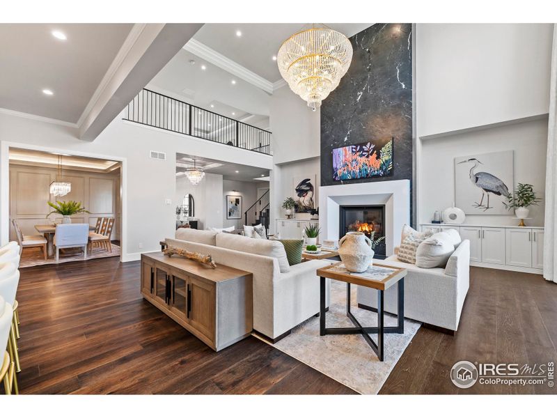 Floor to ceiling fireplace made of Soapstone and Quartz, and custom, remotely operated window coverings