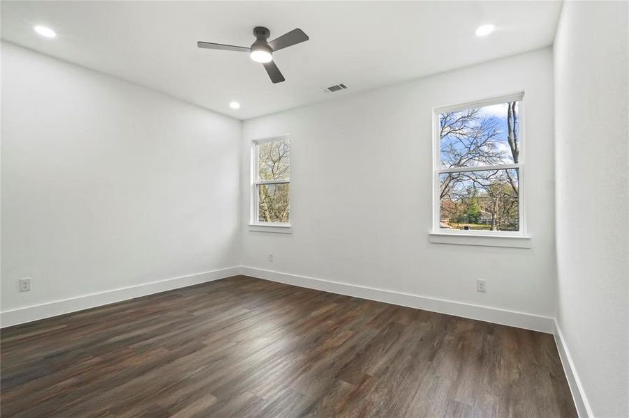 Spare room with dark wood-style flooring, recessed lighting, and a ceiling fan