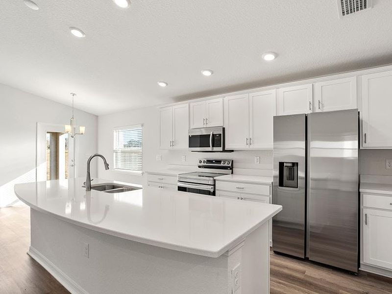 Enjoy an open living area and kitchen with quartz counters, 36-inch cabinets, Samsung appliances, and LVP flooring.