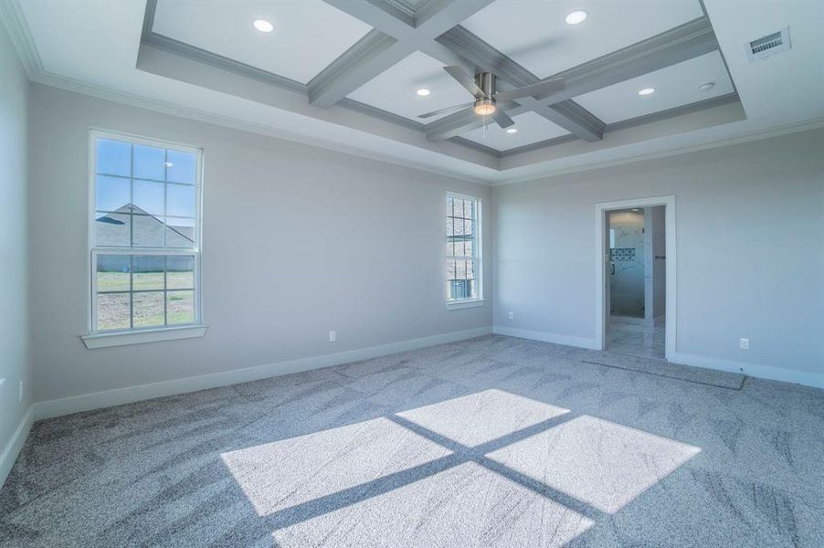 Unfurnished room featuring coffered ceiling, ornamental molding, beamed ceiling, a ceiling fan, and light colored carpet