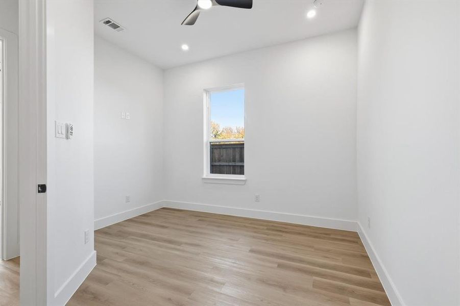 Unfurnished room with light wood-style flooring, a ceiling fan, and recessed lighting Unfurnished room with light wood-style flooring, a ceiling fan, and recessed lighting