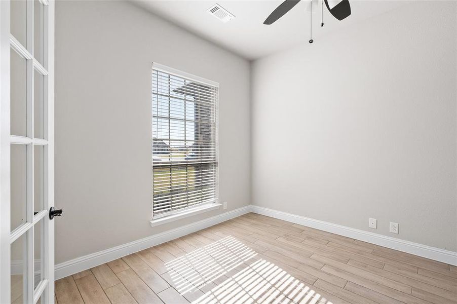 Spare room featuring light wood-style floors and ceiling fan