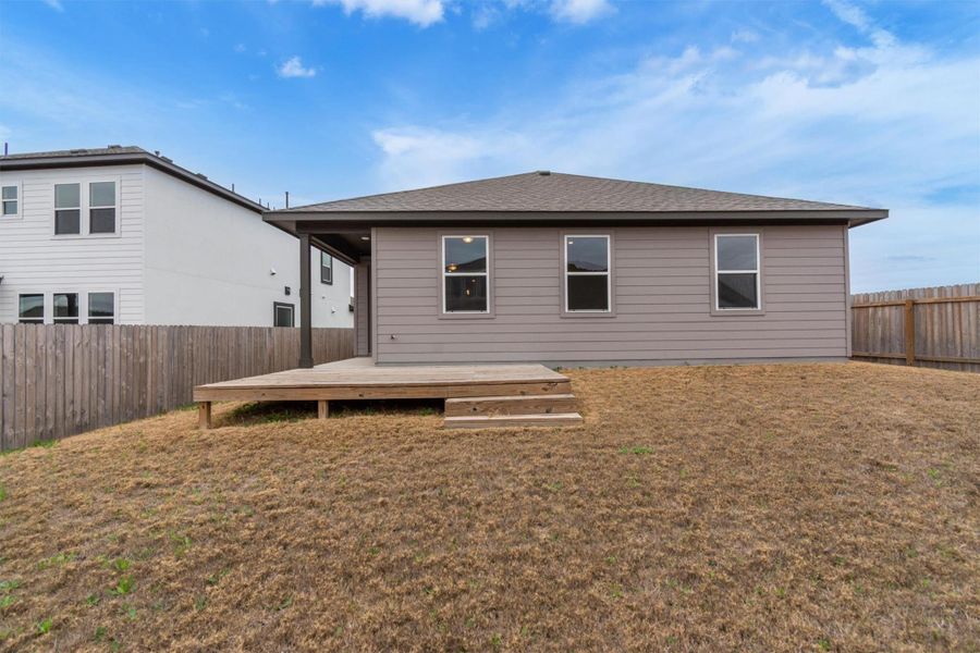 A spacious backyard with a private deck, offering ample room for outdoor activities and future landscaping.