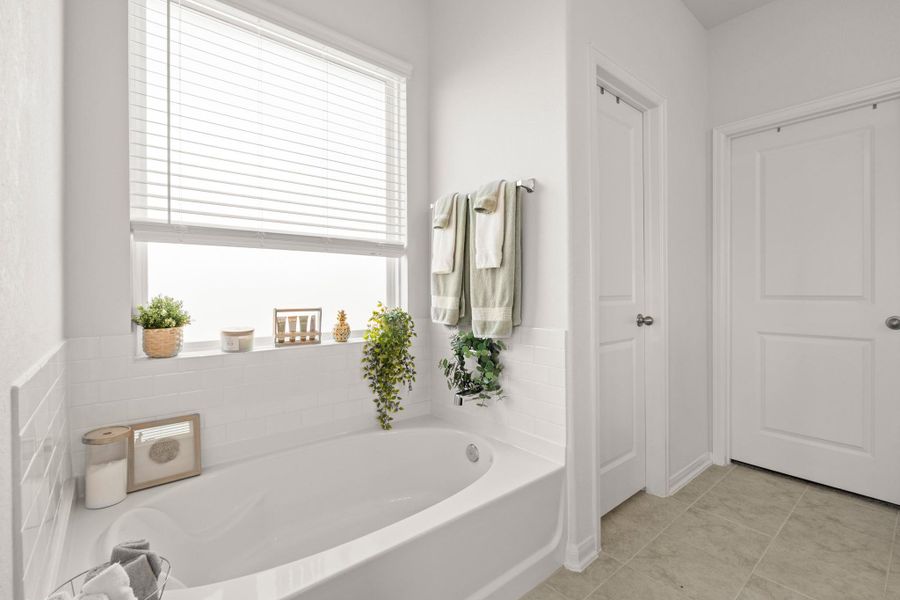 Relax after a long day, the primary bathroom features a separate garden tub for soaking!