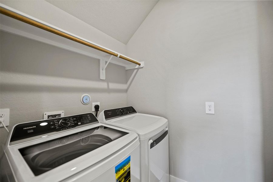 Convenient laundry room with space for full-size washer and dryer.