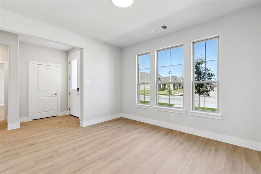 Empty room with light wood finished floors and baseboards Empty room with light wood finished floors and baseboards
